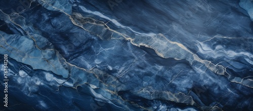 A detailed closeup of a swirling blue marble texture, resembling the fluidity of water, sky, and wind waves. The electric blue hues mimic a landscape of mountains and waves
