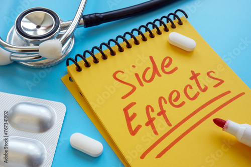 Medical pills and handwritten note side effects.