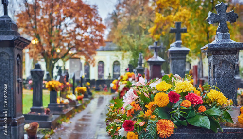 Cemetery, tombstones with flowers in a rainy day in autumn. Memories, sadness, funeral concept