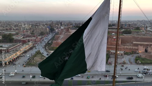 Big Flag of Pakistan in Peshawar in slow motion at sunset time, evening. Bala Hisar Fort Peshawar Pakistan, Drone Aerial photo