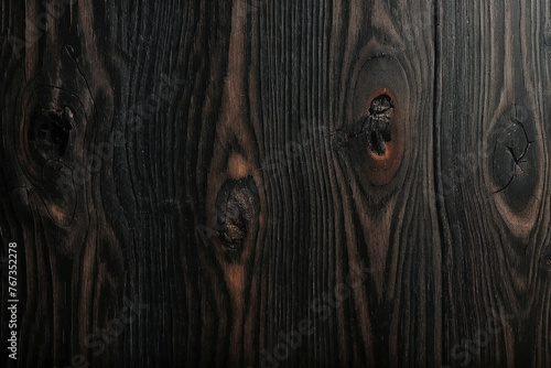 Surface of a Black and Brown Mahogany wood wall wooden plank board texture background with grains and structures