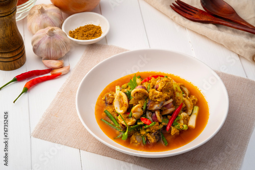 Stir Fried Squid with Curry Powder in white plate ,(pla muk pad pong karee),Thai Food.