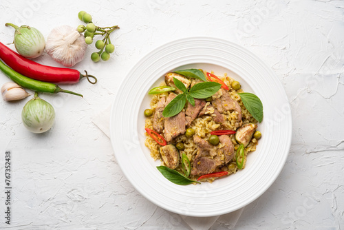 Green Curry Fried Rice with pork meat and basil in white plate.Top view photo