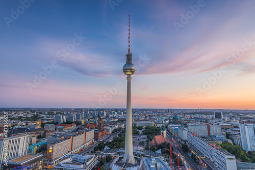 Sunset in Berlin with few clouds. Skyline of the capital of Germany in the center of the city. View of the television tower at Alexanderplatz with the Red Town Hall. Streets and high-rise buildings photo
