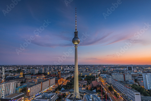 Berlin skyline in the evening. Center of the capital of Germany with famous landmarks. Illuminated TV tower after sunset at blue hour. Illuminated streets and buildings at Alexanderplatz