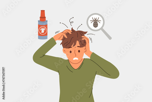 Man with lice in hair experiences discomfort and itching due to parasites, needs medical treatment. Guy with dissatisfied grimace became infected with lice because of non-compliance with hygiene rules