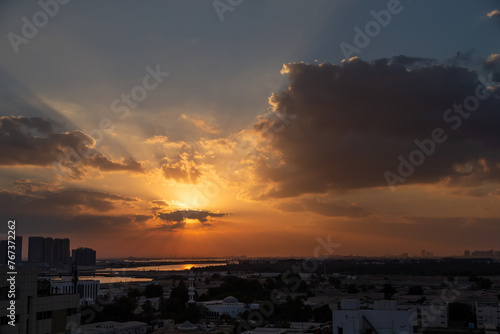 Beautiful vibrant orange sunrise sky with sun rays in Abu Dhabi