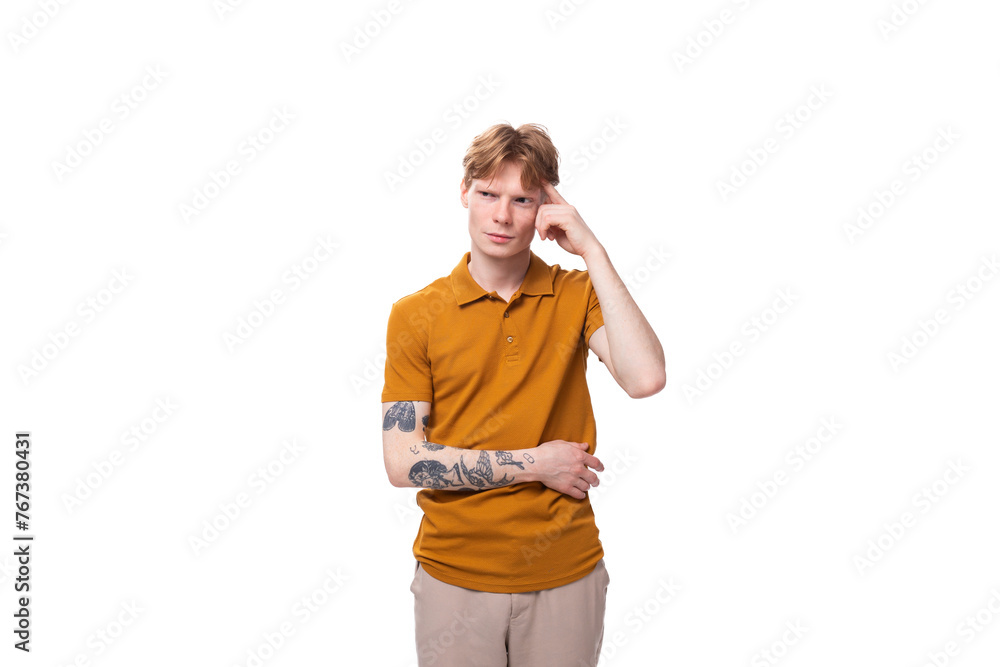 young inspired genius caucasian male student with red hair dressed in yellow t-shirt young inspired genius caucasian male student with red hair dressed in yellow t-shirt