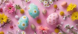 Colorful Easter eggs adorned with flowers on a pink backdrop