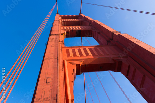 Looking upwards at one of the towers of the Golden Gate Bridge shows the orange color and all nuts and bolts of this landmark.