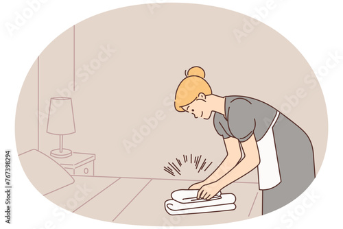 Housekeeper working in hotel room
