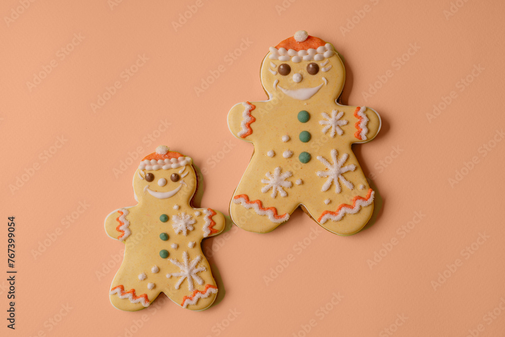 Festive Christmas and New Year gingerbread in the shape of snowman on apricot crush color background