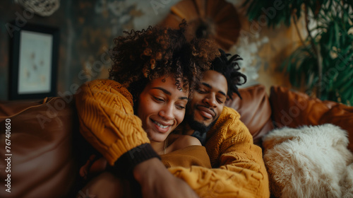 Cozy and affectionate African American couple sharing a hug on a comfortable sofa  surrounded by warm tones