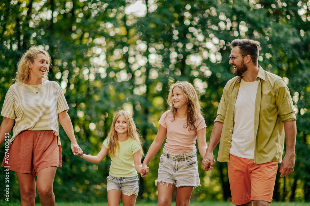 Fototapeta premium Portrait of a happy family walking together in nature.