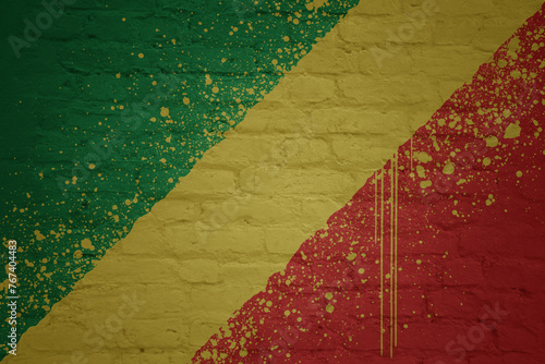 colorful painted big national flag of republic of the congo on a massive brick wall