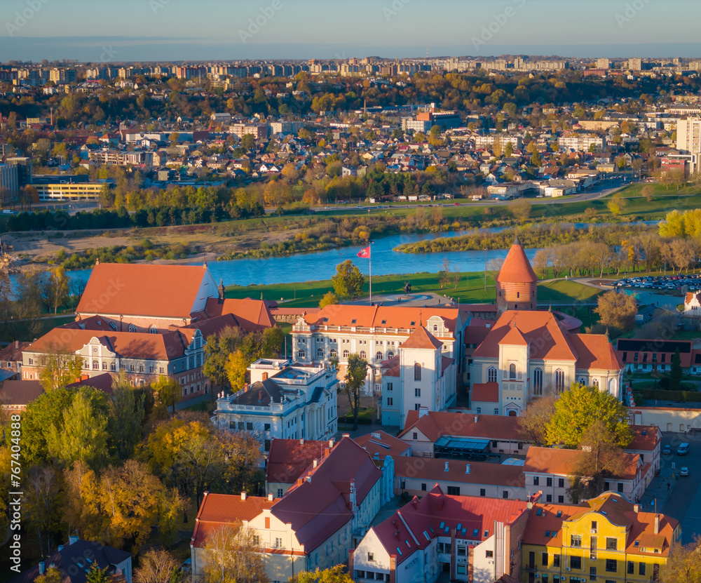 Obraz premium Kaunas old town panorama, Lithuania. Drone aerial view photo of Kaunas city center with many old red roof houses, churches