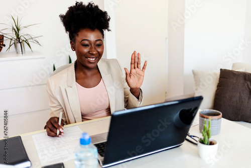 Black woman, typing in home office and laptop for research in remote work, social media or blog in apartment. Freelance girl at desk with computer writing email, website post and online chat in house.