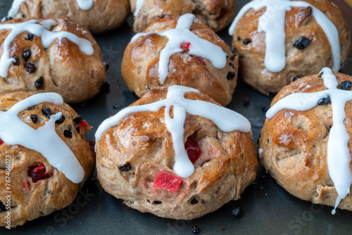 Homemade traditional hot cross buns with fruit and raisins.