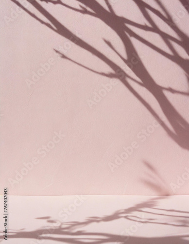 Beautiful original background image of an empty space in pink tones with a play of light and shadow on the wall and floor for design or creative work..