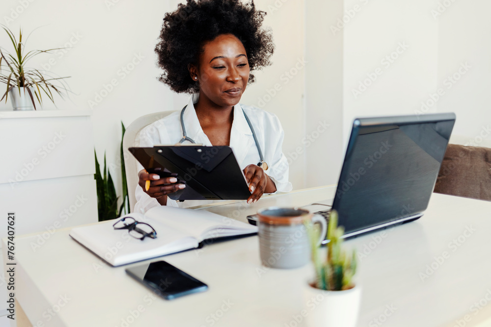 Cropped portrait of an attractive young female doctor taking notes while making a phonecall in her office. Cropped portrait of an attractive young female doctor taking notes while making a phonecall in her office.