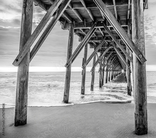 black and white photo of a fishing pier on topsail beach nc