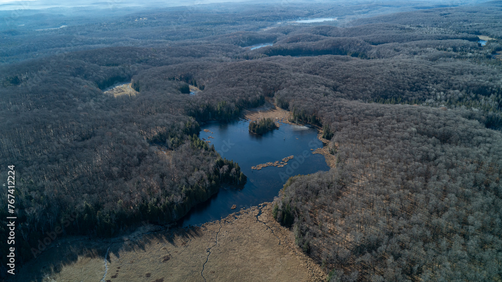 A large pond from an aerial view on a sunny day in the fall A large pond from an aerial view on a sunny day in the fall