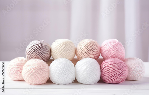 colorful balls of thread and metal knitting needles on a white w