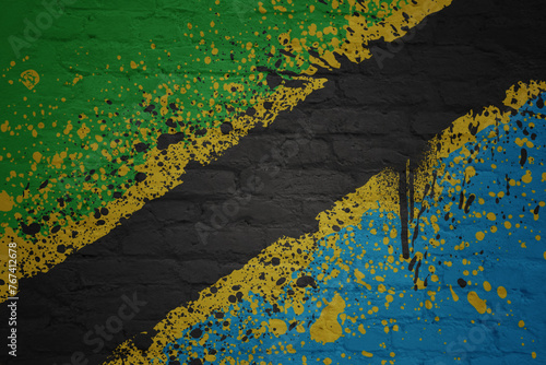 colorful painted big national flag of tanzania on a massive brick wall