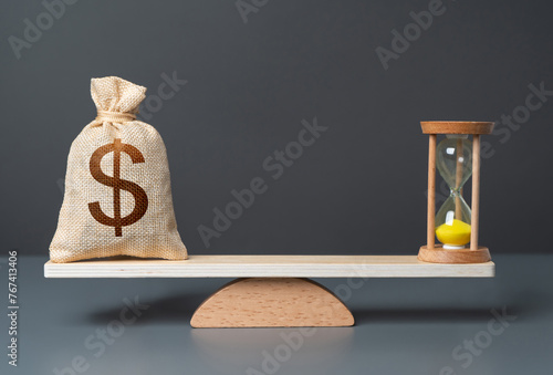 Obraz na płótnie Dollar money bag and hourglass on scales