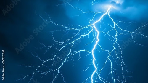  a close up of a lightning bolt on a dark blue sky with a white cloud in the middle of the image.