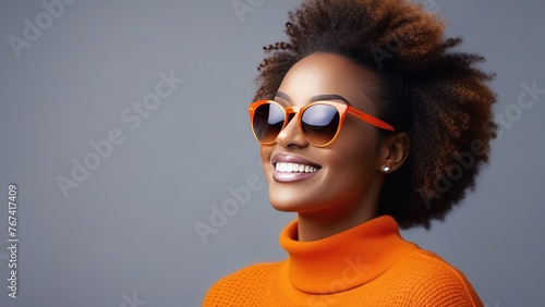 Portrait of a beautiful young Afro-American woman with curly hair and wearing sunglasses on a pink background, banner for a beauty salon or cosmetology, optics salon photo