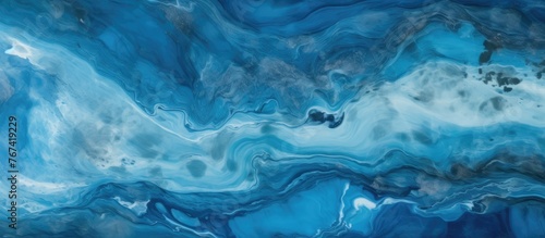 A detailed view of a painting depicting serene blue and white waves crashing on the shore
