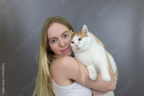 Blonde Girl Holding Pet Cat Close Caring, Pet Owner, Cuddle, Gray Backdrop Isolated Background Posed Portrait