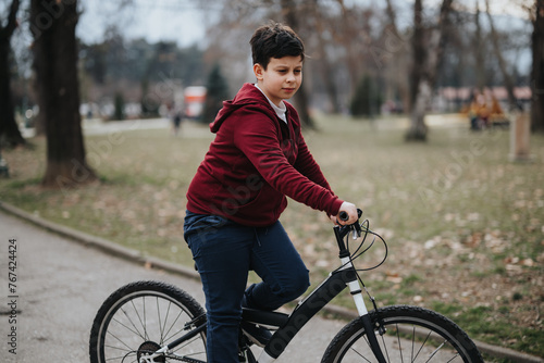 A young boy rides his bicycle through a lush park, embodying leisure, freedom, and the joy of childhood