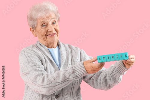 Senior woman with pill box ...