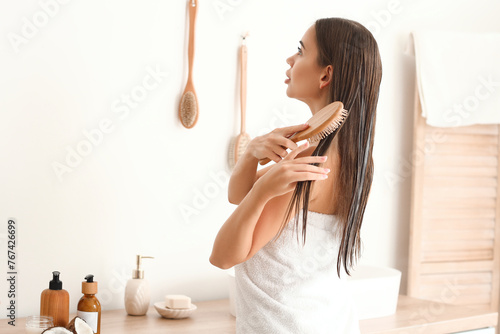 Beautiful young woman brush...