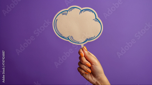 Hand holding thought bubble graphic. Woman's hand holding craft balloon cloud with empty space for text or message.