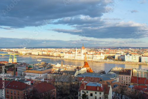 Aerial view on Parliament building, Danube River and City at sunset in Budapest, Hungary. High angle view of buildings and town