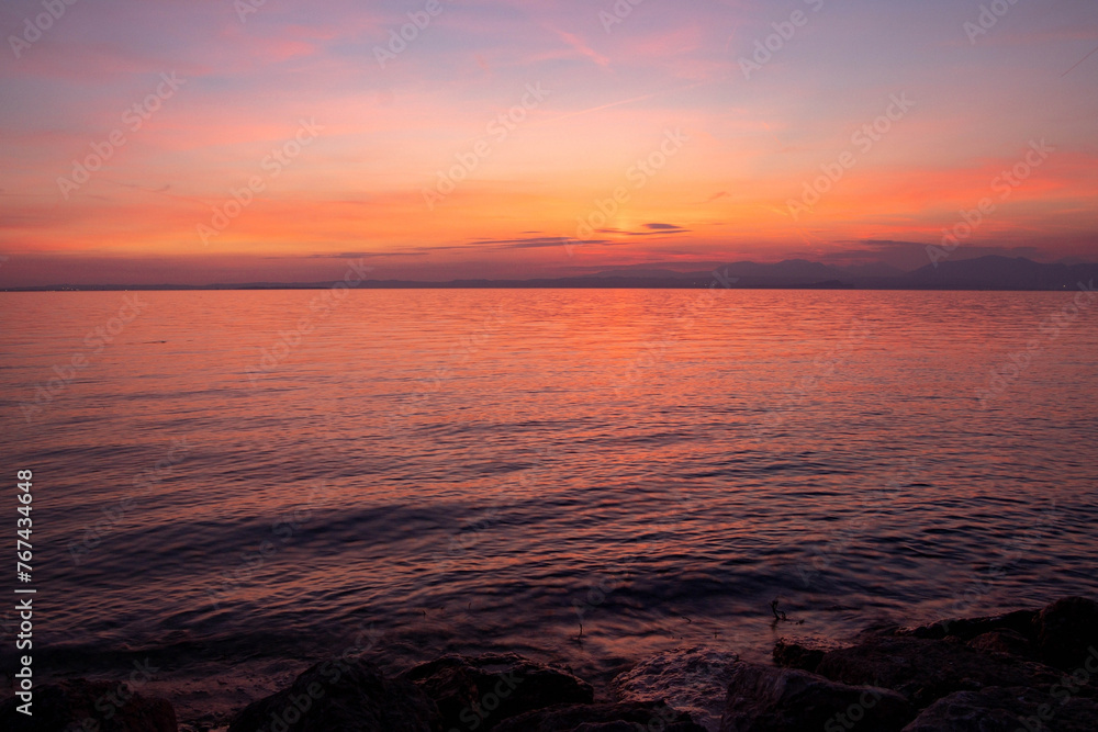 Naklejka premium Lakeview at sunset from walkway at Cisano, Bardolino, Lake Garda, Italy