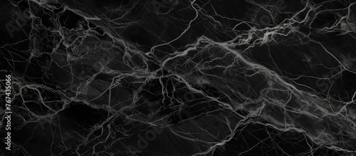 A detailed view of a smooth black marble surface with a distinct white line running through it