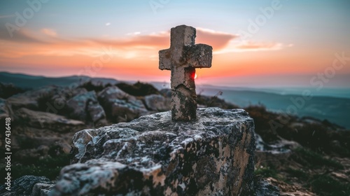 Resurrection symbol empty tomb with cross on meadow at sunrise on good friday concept
