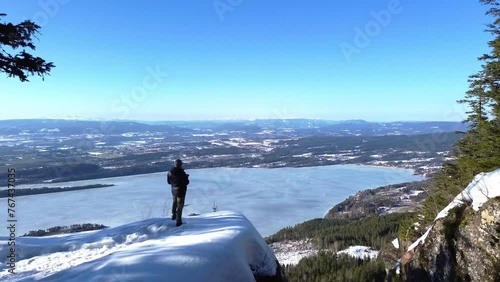 Person in the mountains looking over the big fjord Steinsfjorden from the mountains.  photo