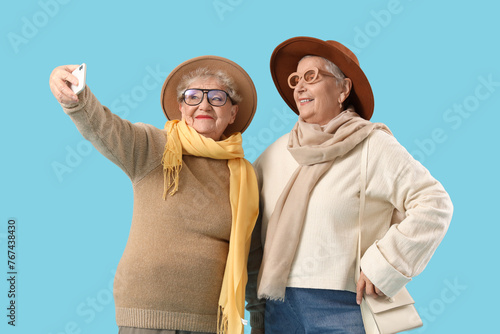 Senior female friends takin...