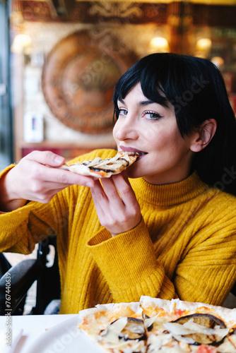 Woman Savoring Delicious Pizza in Yellow Sweater