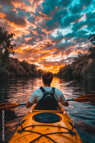 Kayaker man paddling kayak at sunset sea, rear view adventure in canoe, recreational paddling