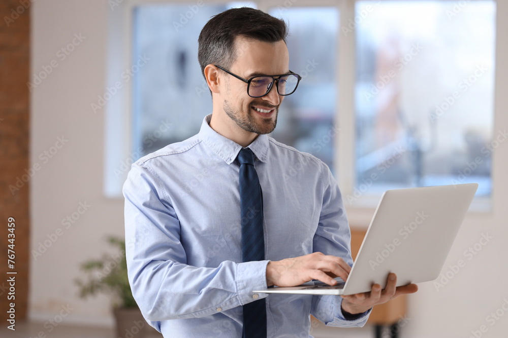 Portrait of male real estate agent with laptop in new apartment Portrait of male real estate agent with laptop in new apartment