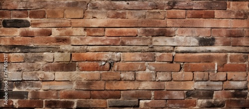 An up-close view of a brick wall showing a tiny hole in the structure