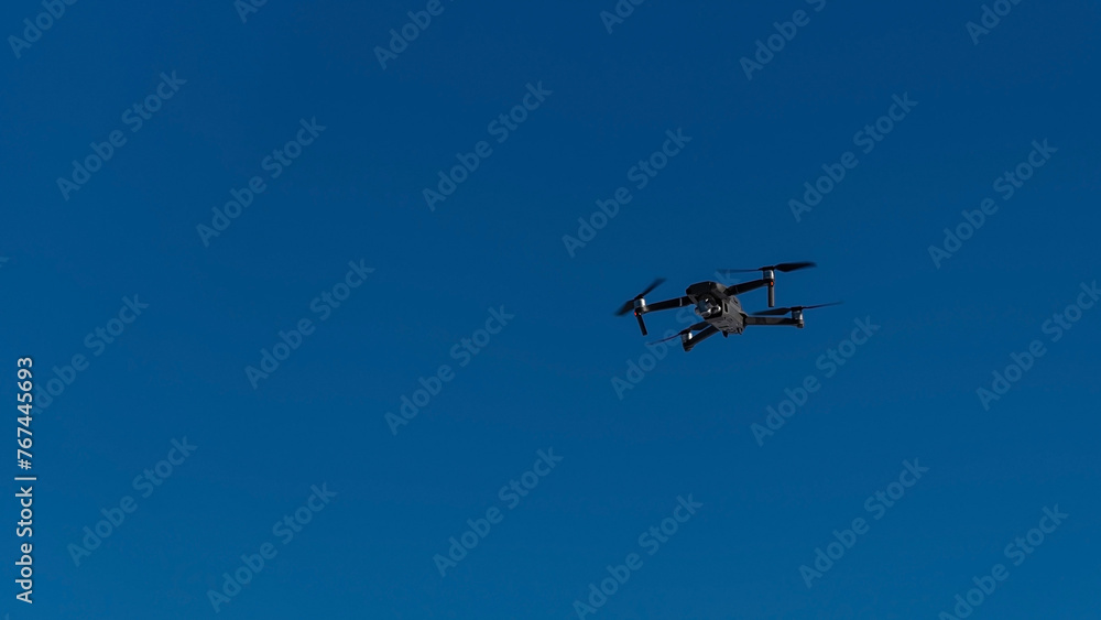 quadcopter flies in blue sky
