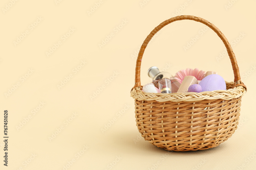 Wicker basket with decorative cosmetics and Easter eggs on beige background Wicker basket with decorative cosmetics and Easter eggs on beige background