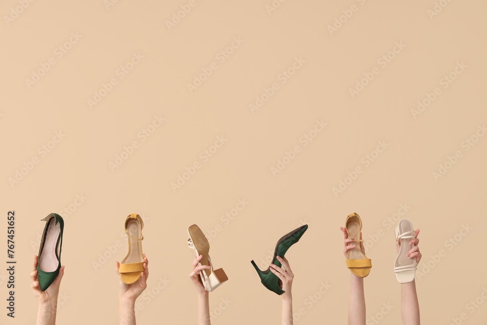 Women with stylish high-heeled shoes on beige background Women with stylish high-heeled shoes on beige background